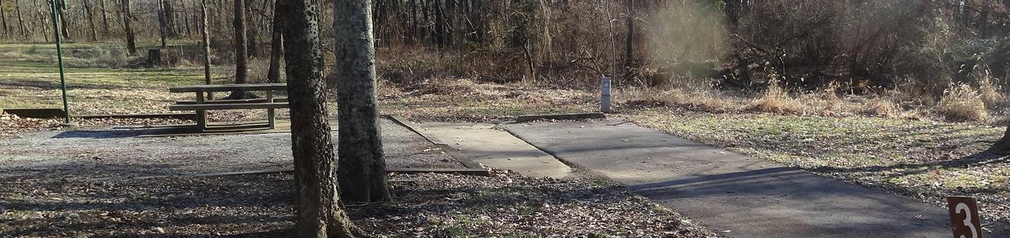 This site has a picnic table and fire pit on the left side of the paved pads. The hookups for this site are located to the right rear side of the paved parking pad. There is a walking/bike path near by and has an additional pad for camping supplies. 