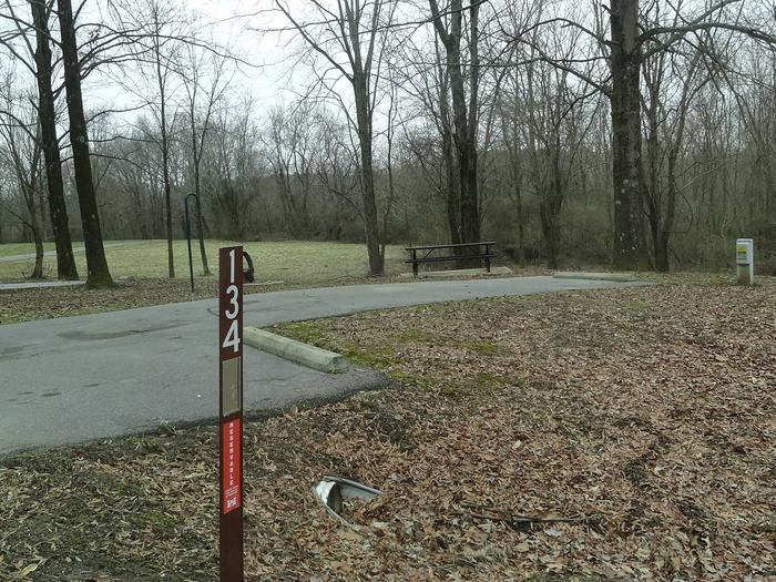 picnic table and fire pit located to the left of camp pad, electric and extra parking to the right of pad. located near bathroom