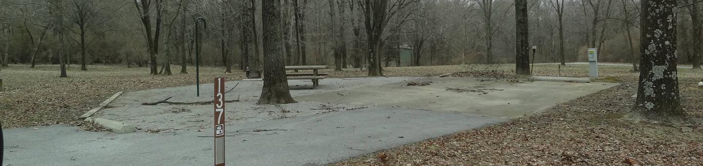 picnic table, fire pit, and extra parking located to the left of camp pad, electric, water,and sewer to the right of pad.