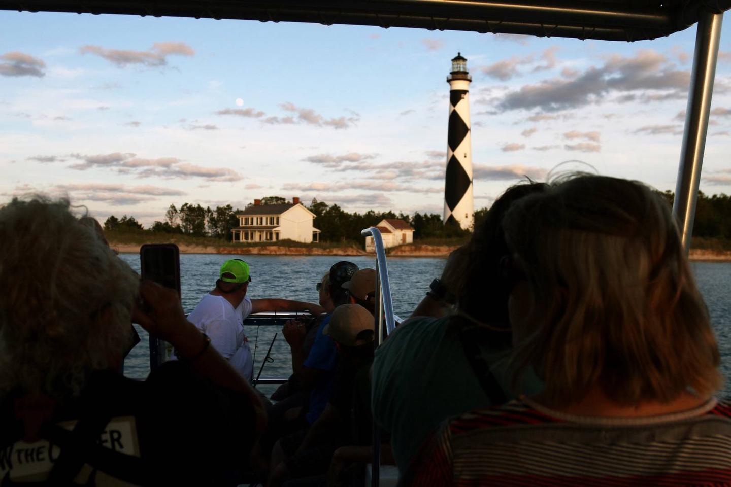 View of Cape Lookout Lighthouse Area from the ferry.Participants of the Evening at the Cape Tour arrive to the Lighthouse area, the evening's main attraction.  