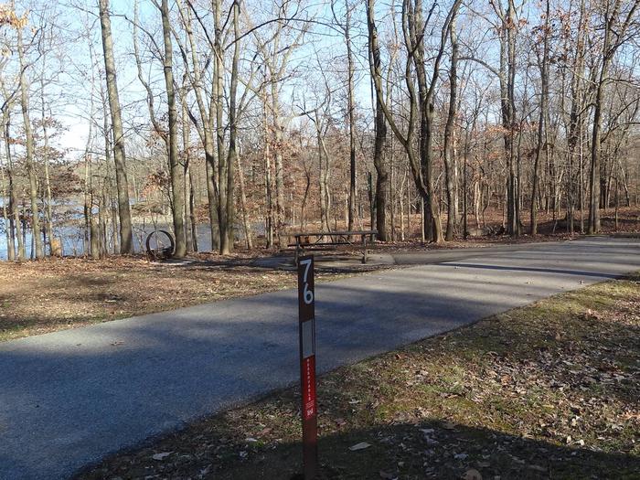 This site is near the waters edge providing a great view of the lake. The picnic table and fire pit are of the left side of the paved parking/camping pad. The electricity hookup is on the right side. 