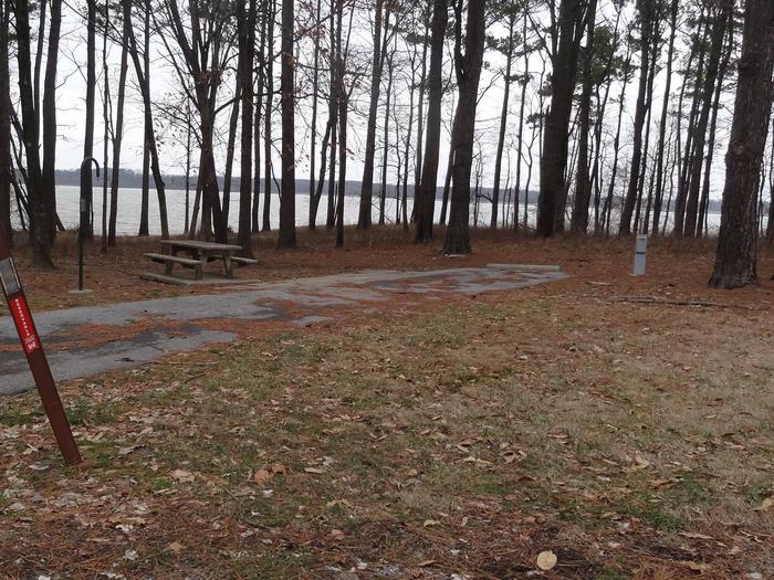 There is a great view of the lake at this site. The picnic table and fire pit are located on the left side of the paved parking pad and the hookups are at the rear right corner of the pad. 