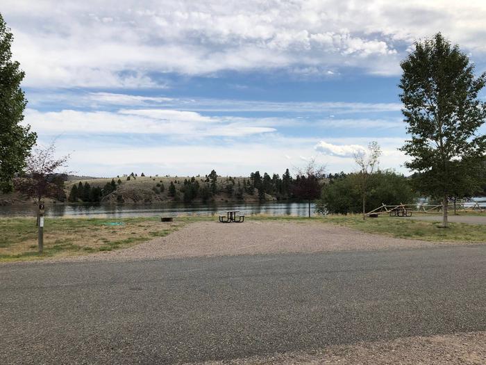 Site 7 BLM White Sandy Campground.  Lakeside campsite on Hauser Lake. Gravel camping pad with picnic table and fire pit. Paved access within campground.Site 7 BLM White Sandy Campground.