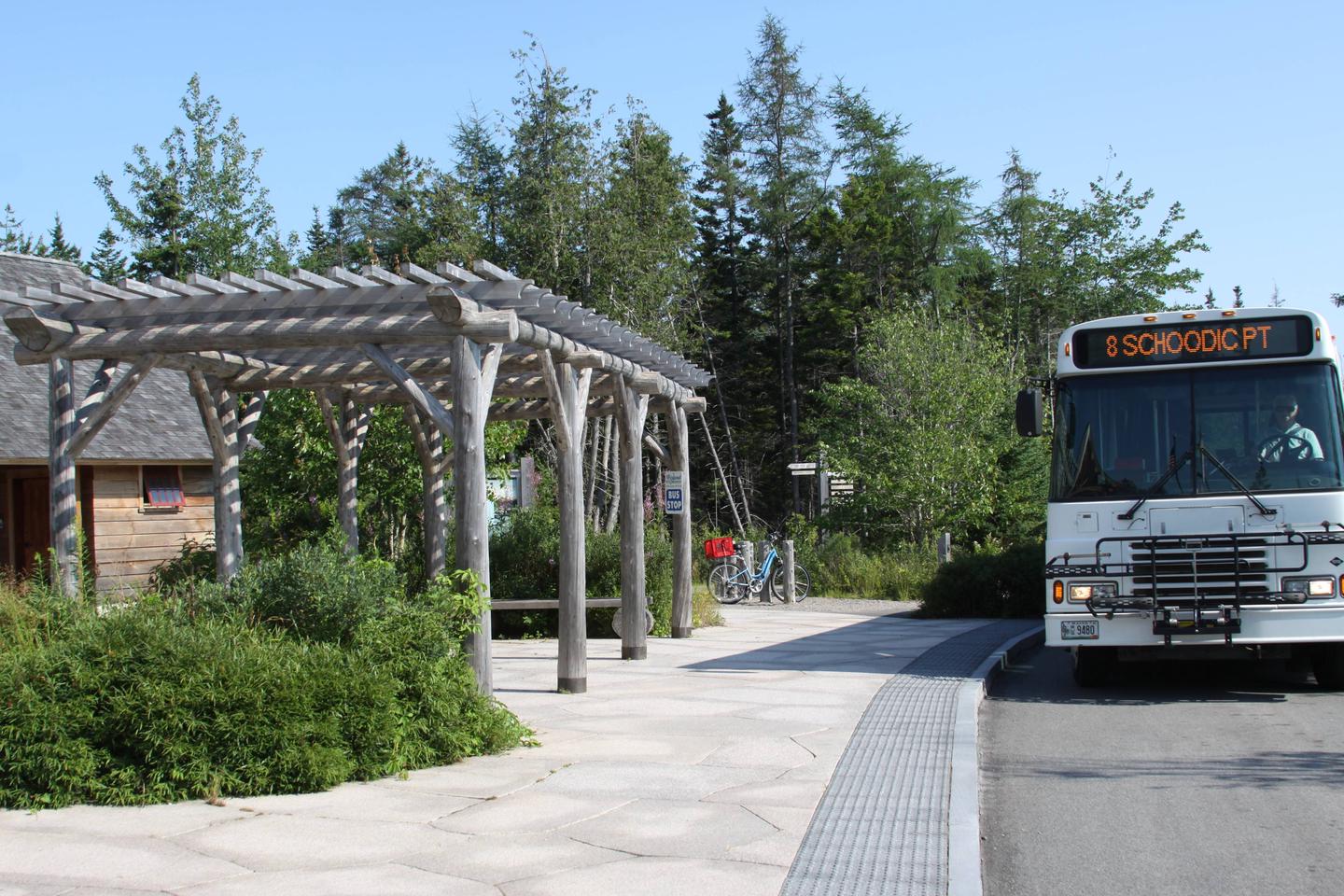 Shuttle bus waiting at a bus stop.Island Explorer Bus Stop at Schoodic Woods