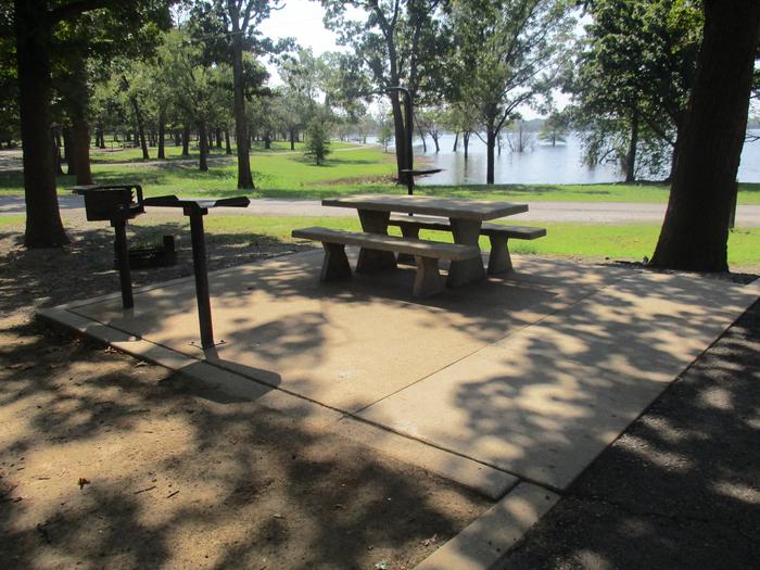 Site 25 table - Flat RockSite 25 offers a concrete picnic table, pedestal grill, metal utility table and fire ring.