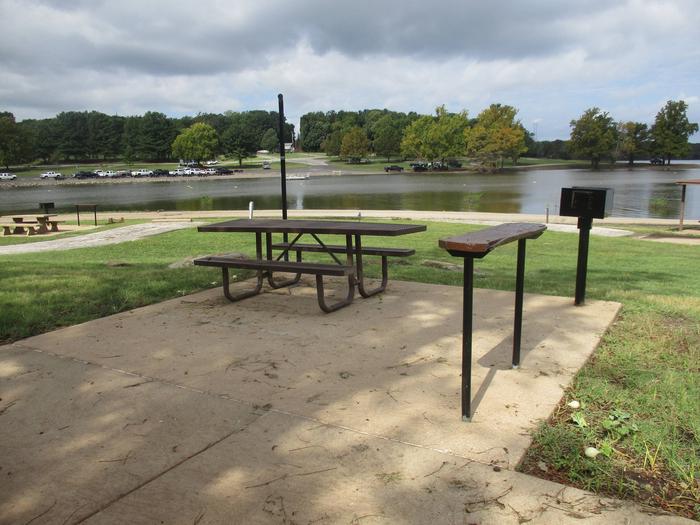 Site 6 - Rocky PointSite 6 offers a metal picnic table, utility table, pedestal grill, fire ring and lantern holder.