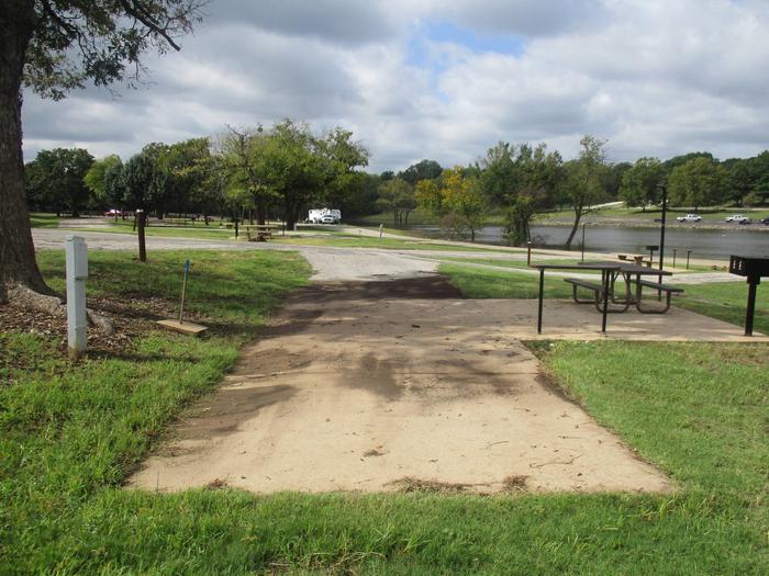 Site 6 drive - Rocky PointSite 6 offers a concrete parking surface for camping equipment.  The campsite has partial shade.