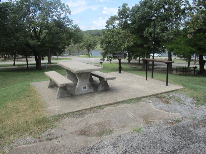 Site 16 - Rocky PointSite 16 offers a concrete picnic table, utility table, pedestal grill, lantern holder and fire ring.