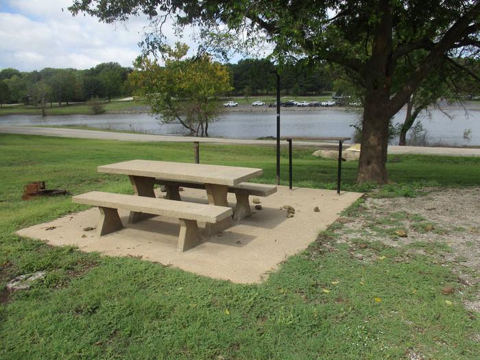 Site 24 - Rocky PointSite 24 offers a concrete picnic table, utility table, pedestal grill, lantern holder and fire ring.