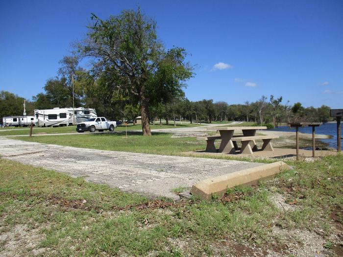 Site 24 drive - Blue BillSite 24 offers an asphalt drive and has a large grassy area for tents.