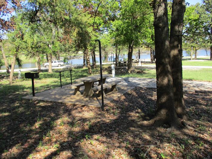 Site 41 - Rocky PointSite 41 offers a concrete picnic table, pedestal grill, utility table, lantern holder and fire ring.