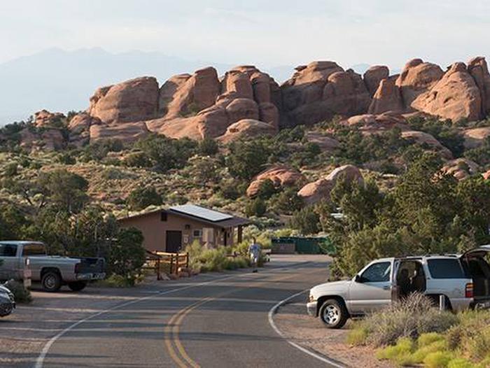 Campground road lined with campsites and boulders in the background.Devils Garden Campground