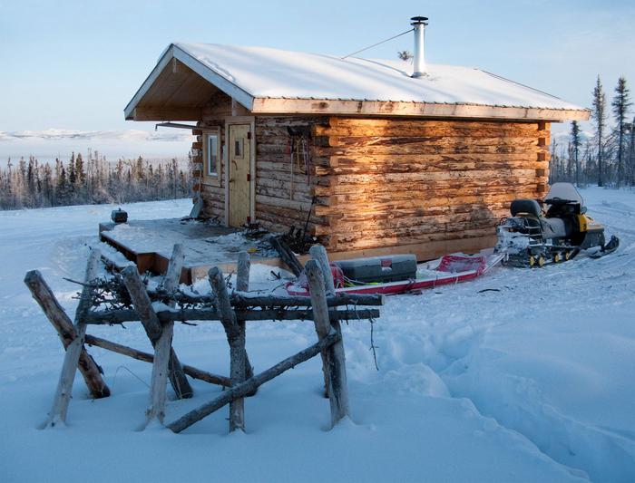 Log cabin and snowmobile in winterCrowberry Cabin