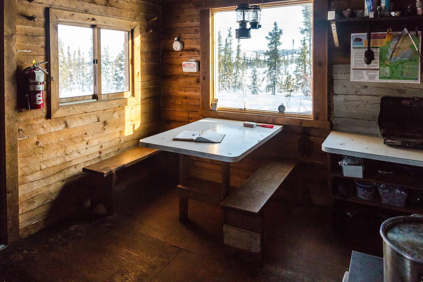 Cabin interior with a table and counterTable and cooking area at Colorado Creek Cabin