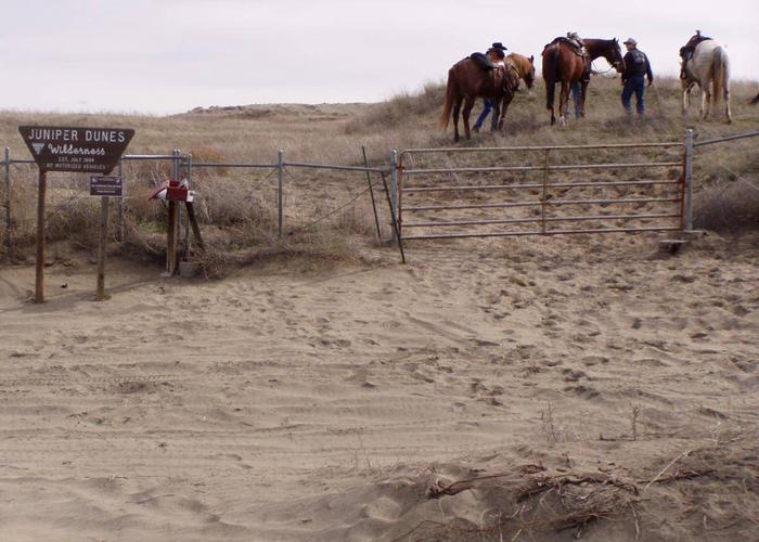 Equestrians assemble at the Wilderness Gate before a ride into the Juniper Dunes Wilderness