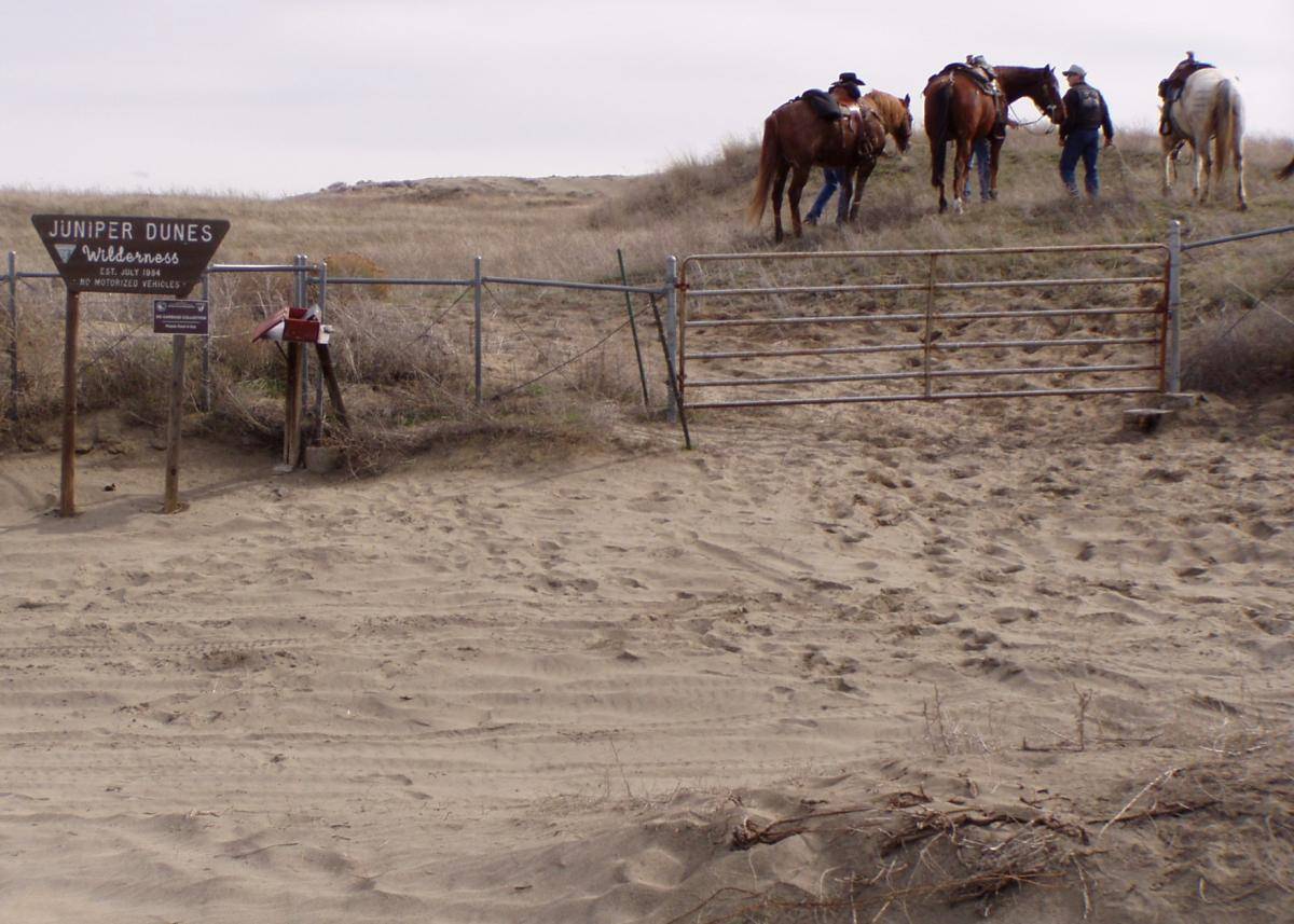 Equestrians assemble at the Wilderness Gate before a ride into the Juniper Dunes Wilderness