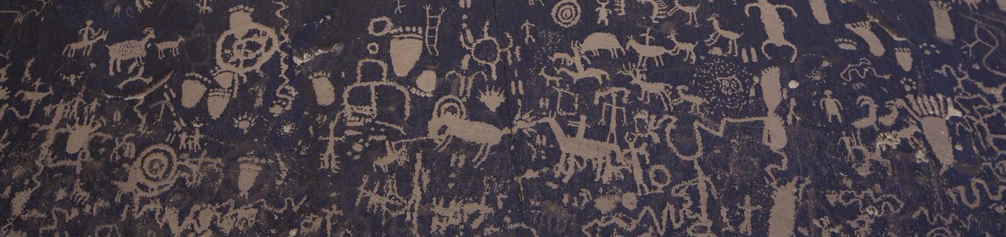 Petroglyphs at Newspaper RockView of petroglyphs on dark rocks 