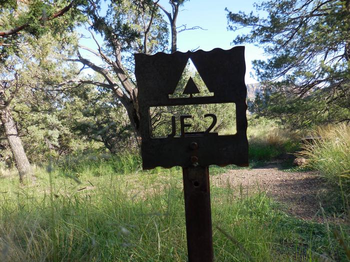 Flat area with Juniper trees with a view of mountainsFlat campsite with Juniper trees and a bear box. Great views