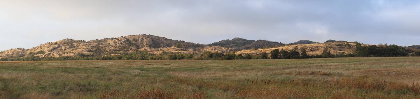 Granite mountains rise above the grasslands. The refuge's rugged landscape is the result of over half a billion years of geologic change and adaptation.