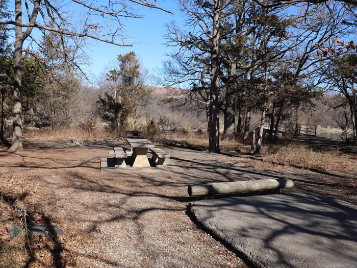 An open campsite with a view of the lake and adjacent to the Quanah Park Lake Trail.Campsite 26