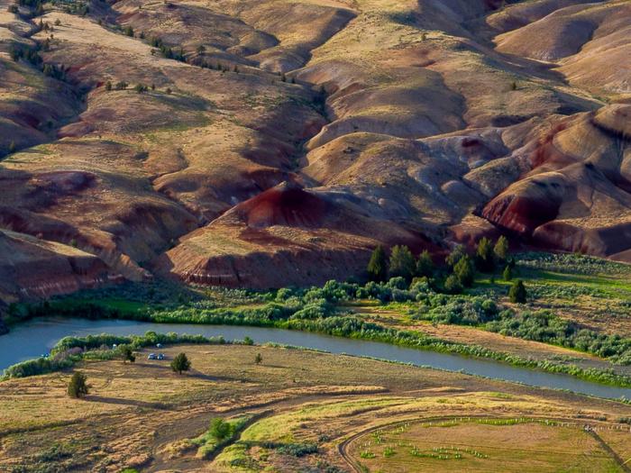 The John Day River winding through red and yellow clay hills The John Day River near Priest Hole.