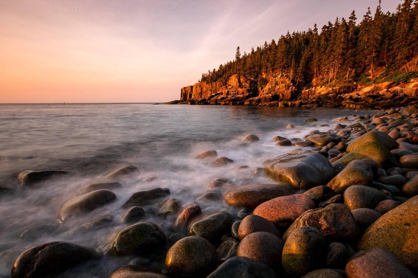 Acadia National Park’s Otter Cliffs climbing area in the distance at sunrise.