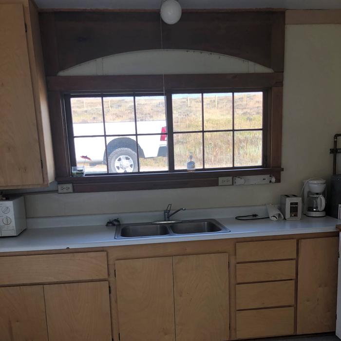 Kitchen WindowKitchen window looks to the north, coffee pot, can opener, micro wave