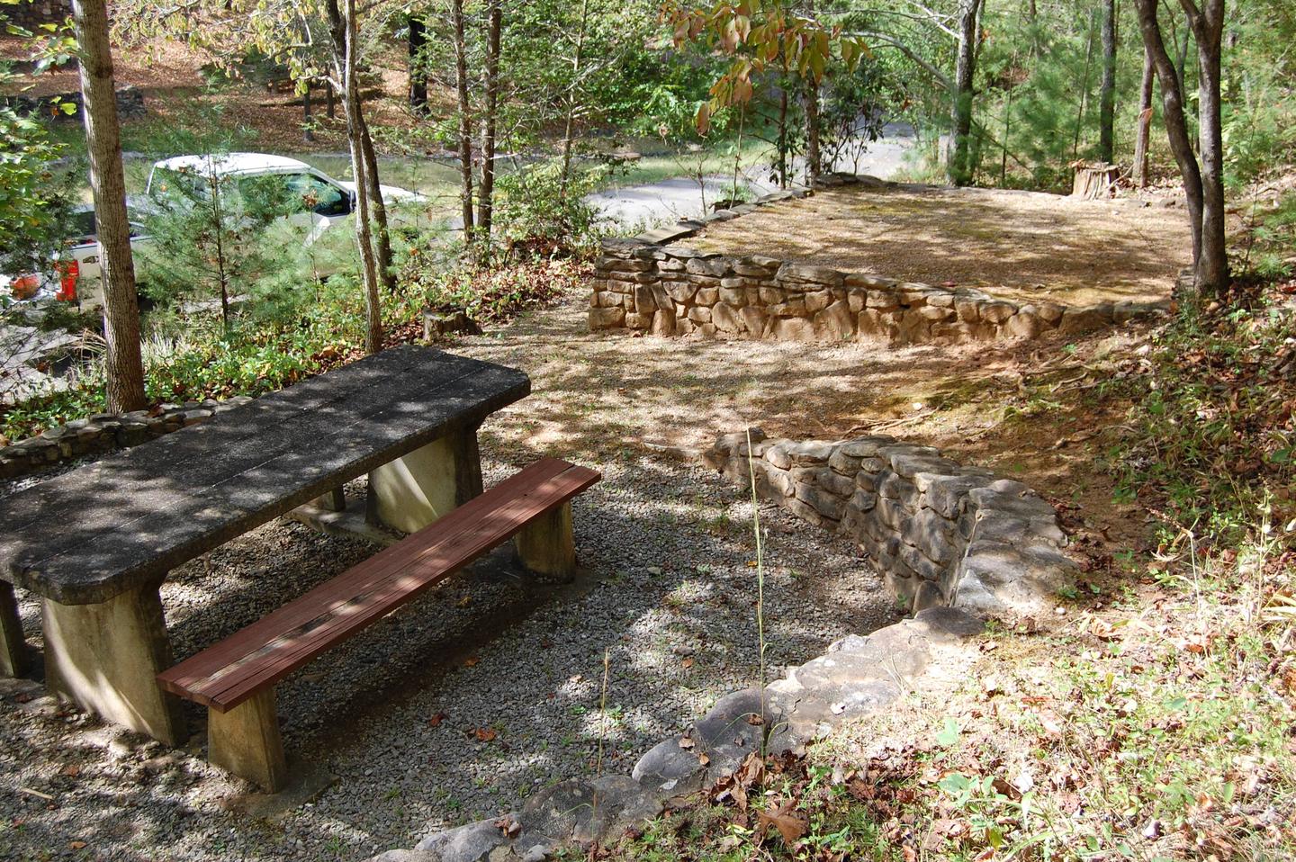 10 picnic area and tent pad The picnic area sits above the paved loop on the exterior. The site is not large but is nice and private. Please note the site does feature stairs.