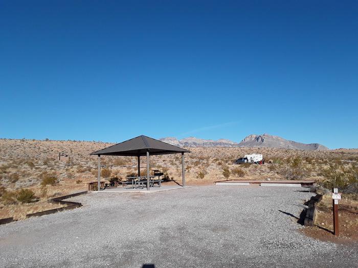 Red Rock Canyon Campground Standard Site 11 Red Rock Canyon Campground Standard Site that has a shelter with a picnic table on a cement slab. There is also a nice fire pit with seating. A  large tent pad and plenty of parking for two vehicles or a recreational vehicle and vehicle as well.