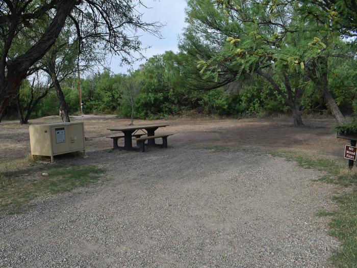 View of the main site area for site 44. There is a bear box, picnic table, and metal grill with plenty of space to pitch a tent or shelter. Site 44 