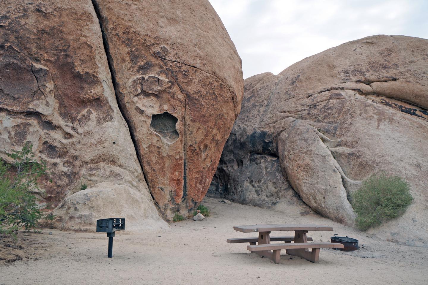 Campsite  with picnic table surrounded by boulders.Campsite.