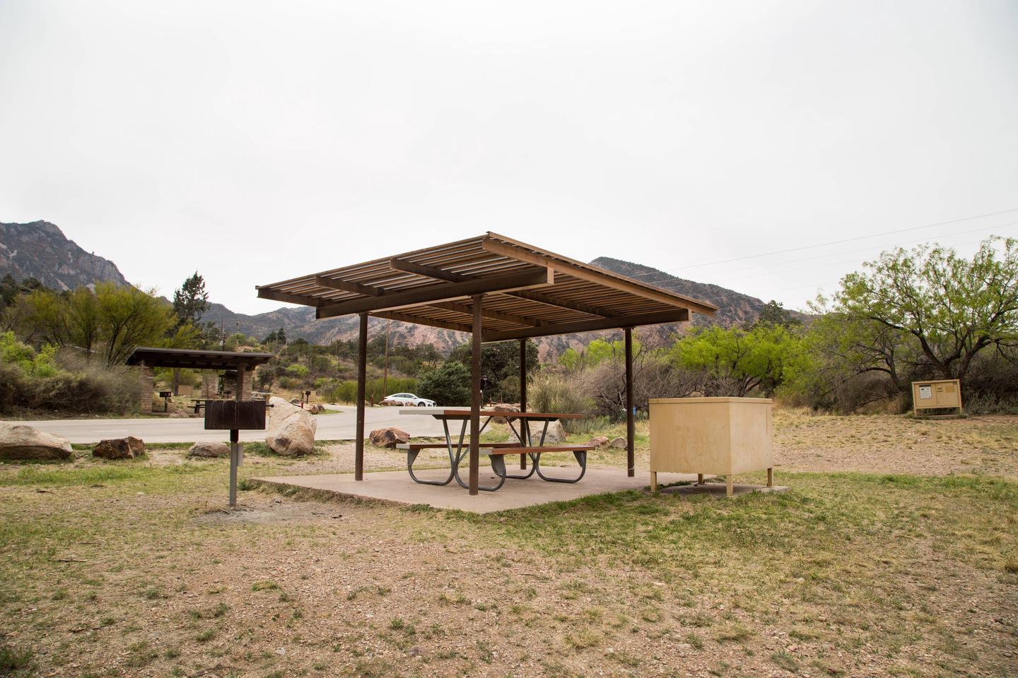 Chisos Basin Campsite #25 shade ramadaShowing tent pad, grill, picnic table, and bear box
