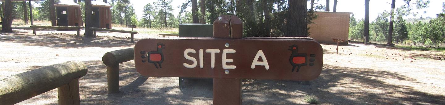 Brown wooden sign with "Site A" engraved on itSite A at Ponderosa Group Campground