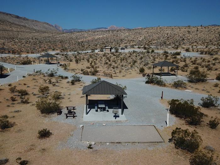 Aerial view of a standard campsite with a shade shelter. 