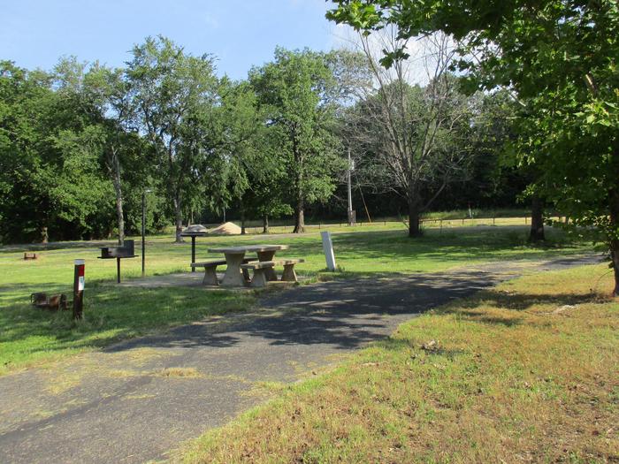 Site 7 has a shaded picnic area in the afternoon.Site 7 has a large grassy area for extra tents or room for the kids to play.
