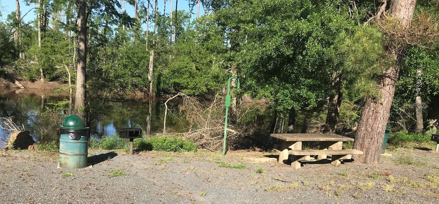Campsite #3.Campsite #3. Tent site with the following amenities: fire-pit, grill, picnic table, lantern pole, trash can.  Located along bayou.