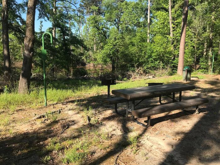 Campsite #6.Campsite #6. Tent site with the following amenities: fire-pit, grill, picnic table, lantern pole, trash can.  Located along bayou.
