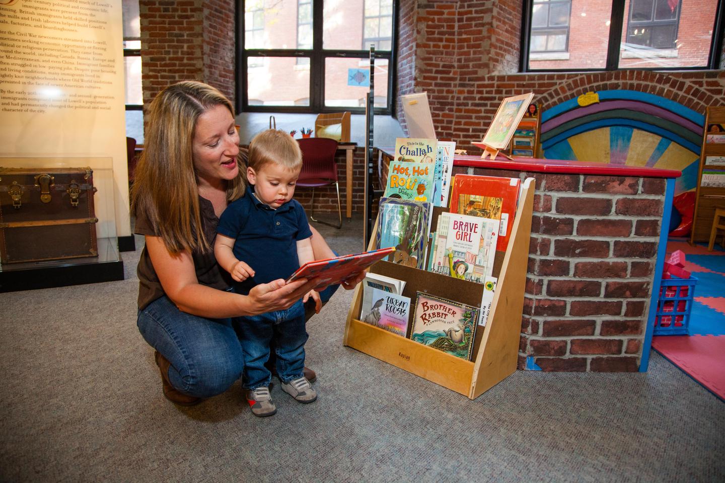 A mother and son read together in the Children's Corner