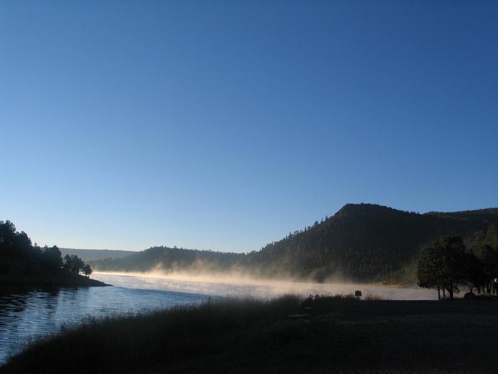 Landscape near Quemado Lake showing mist rising off lake