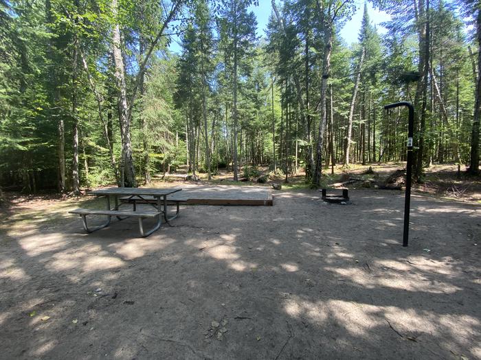 Tent pad, picnic table, fire ring and lantern pole. 