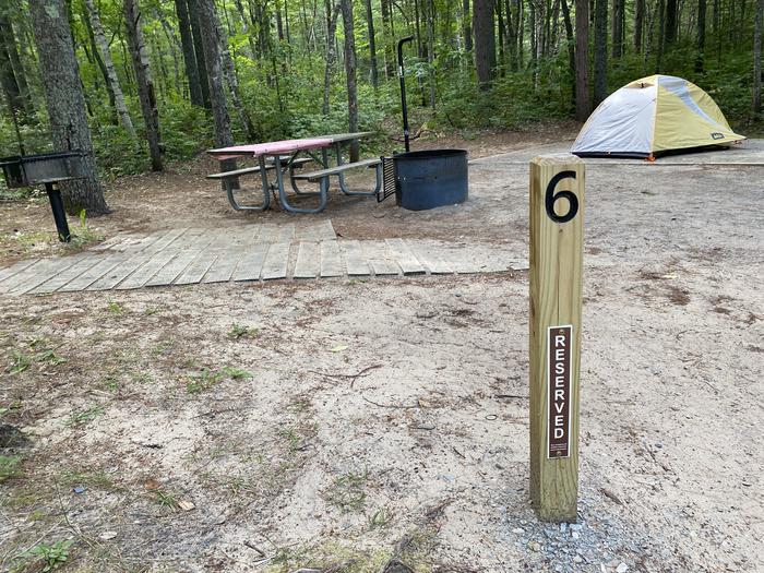 Tent pad, accessible picnic table and fire ring, lantern pole.