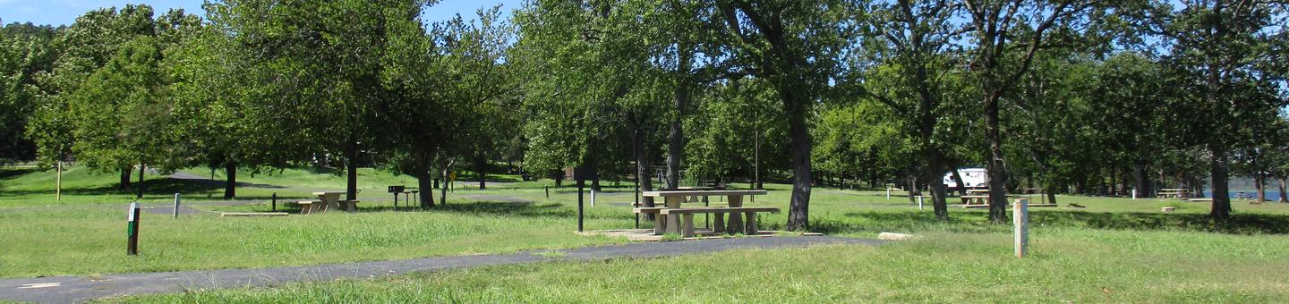 Site 14 - WildwoodSite 14 is a back-in site surrounded by a large green space.  Site offers minimal shade at picnic table.