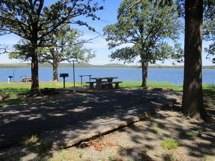 Wildwood - Site 23Site 23 offers a concrete picnic table, pedestal grill, utility table, lantern holder and fire ring.