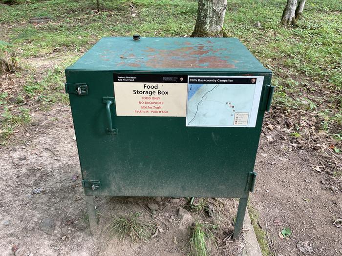 A bear box in the middle of a campground.