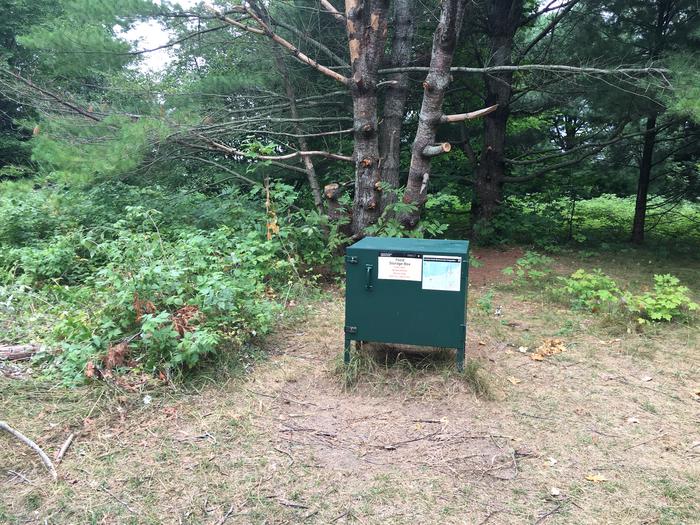 Bear box in front of trees