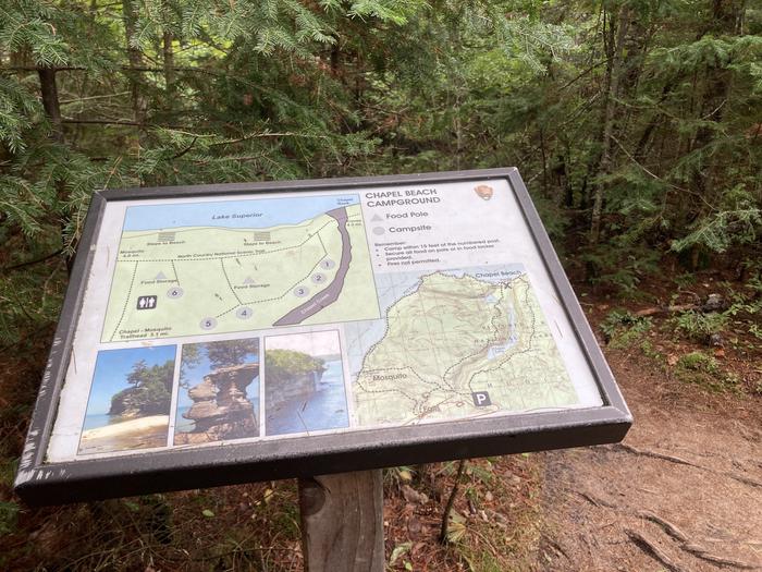 A sign on a wooded trail.