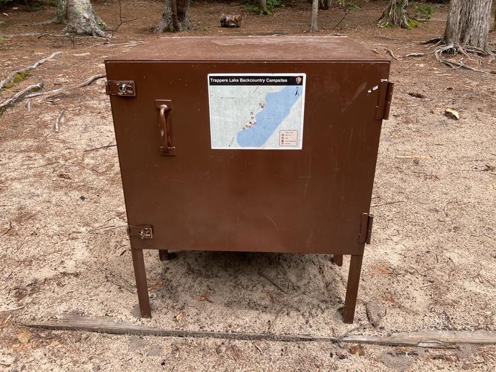 A bear proof container in a campsite.The bear box at Trappers Group. All food and scented items including toiletries must be stored in this box.
