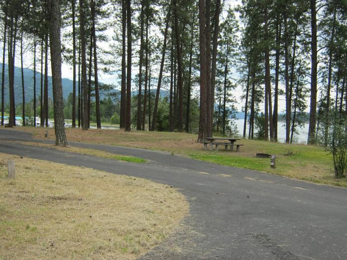 Pine trees and lake in the back dropPull through paved parking