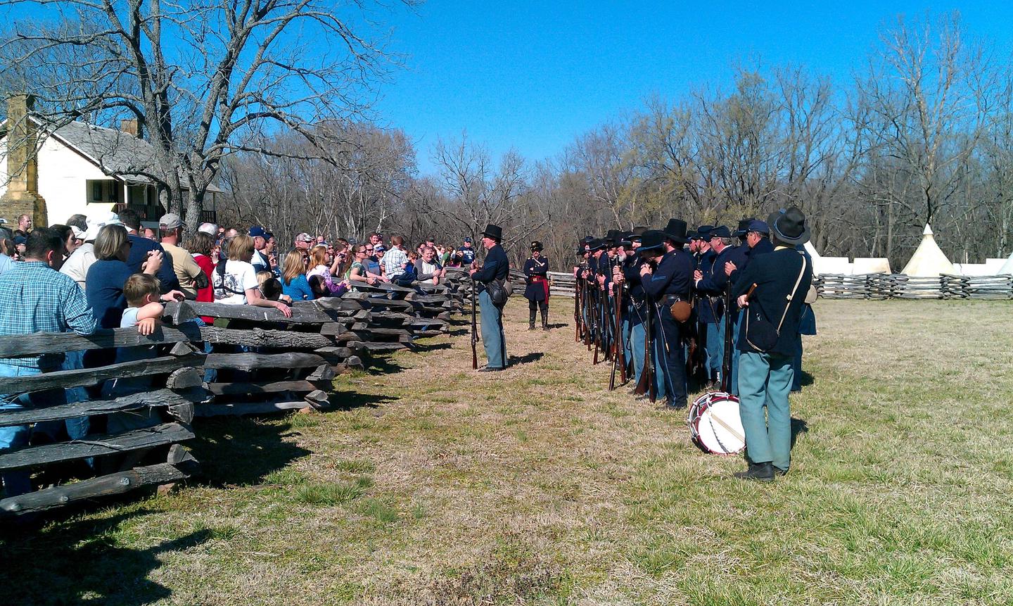 Union Infantry 150thPhoto of Union Infantrymen reenactors standing in front of the Elkhorn Tavern, with large crowd during demonstration on the 150th anniversary of the Battle of Pea Ridge. .
