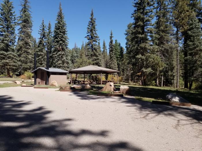 Parking area with picnic area and bathroom in the background.Parking lot for Clear Creek Group campground.